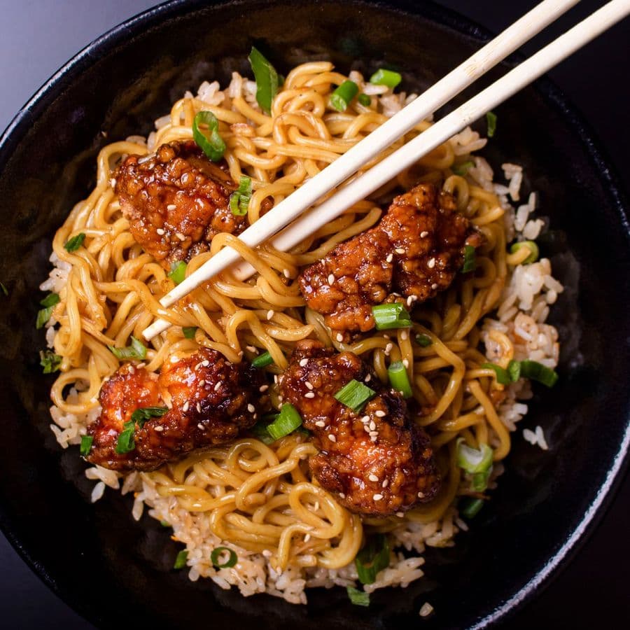 Noodles topped with glazed chicken
