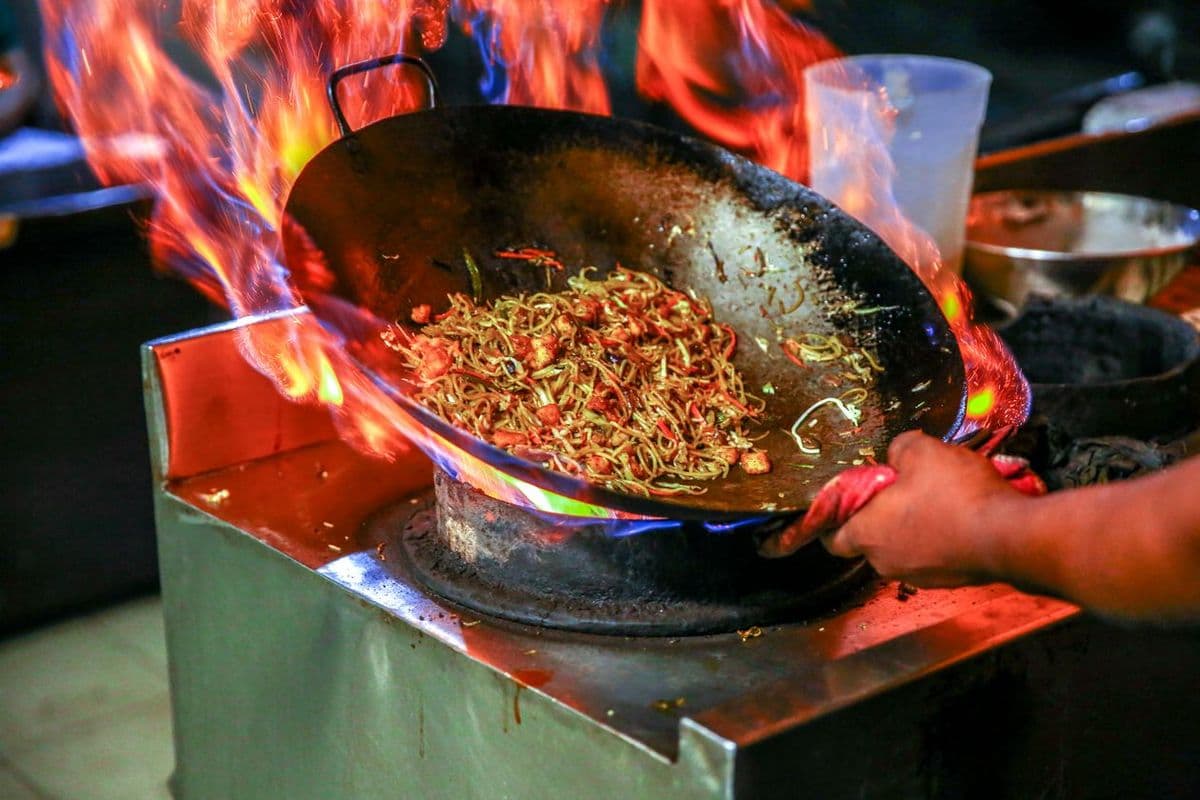 Noodles tossed in a flaming wok